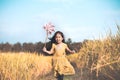 Cute asian little child girl playing with wind turbine Royalty Free Stock Photo