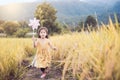 Cute asian little child girl playing with wind turbine Royalty Free Stock Photo