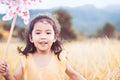 Cute asian little child girl playing with wind turbine Royalty Free Stock Photo