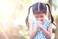 Cute asian little child girl praying with folded her hand Royalty Free Stock Photo