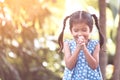 Cute asian little child girl praying with folded her hand