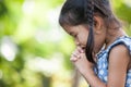 Cute asian little child girl praying with folded her hand Royalty Free Stock Photo