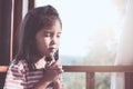 Cute asian little child girl praying with folded her hand Royalty Free Stock Photo