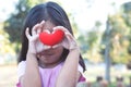 Cute asian little child girl with red heart on the eyes Royalty Free Stock Photo