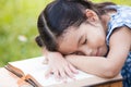 Cute asian little child girl is sleeping and lie down on book Royalty Free Stock Photo