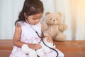 Cute asian little child girl with stethoscope playing doctor Royalty Free Stock Photo