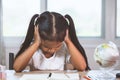 Cute asian little child girl stressed and tired while doing her homework Royalty Free Stock Photo