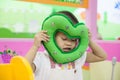 Cute asian little girl close her eyes with green heart pillow Royalty Free Stock Photo
