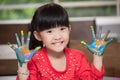 Cute asian little girl with hands in paint , in classroom school  concept - happy children showing painted hand palms at preschool Royalty Free Stock Photo