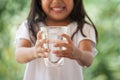 Cute asian little girl holding glass of fresh water Royalty Free Stock Photo