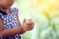 Cute asian little girl is holding melting ice cream waffle cone Royalty Free Stock Photo