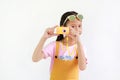 Cute Asian little girl kid taking picture with photo camera toy isolated on white background Royalty Free Stock Photo