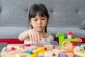 Cute Asian little girl playing with colorful toy blocks, Kids play with educational toys at kindergarten or daycare. The creative Royalty Free Stock Photo