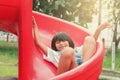 Cute asian little girl playing slider in the playground Royalty Free Stock Photo