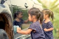 Cute asian little girl washing car Royalty Free Stock Photo