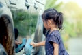 Cute asian little girl washing car Royalty Free Stock Photo