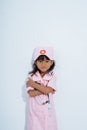 Cute asian little girl wearing doctor uniform with hands crossing