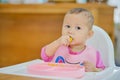 Cute Asian baby girl child eating by hands, Little baby eating vegetables with BLW method, baby led weaning, Self Feeding concept Royalty Free Stock Photo