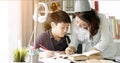 Cute asian mother helping your son doing your homework . Royalty Free Stock Photo