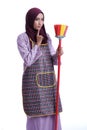 Asian Muslim wearing apron and hold a broom
