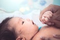 Cute asian newborn baby girl lying down on her bed Royalty Free Stock Photo