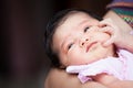 Cute asian newborn baby girl resting on mother`s arm Royalty Free Stock Photo