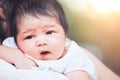 Cute asian newborn baby girl resting on mother`s shoulder Royalty Free Stock Photo