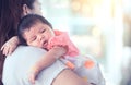 Cute asian newborn baby girl resting on mother`s shoulder Royalty Free Stock Photo