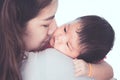 Cute asian newborn baby girl resting on mother`s shoulder. Royalty Free Stock Photo