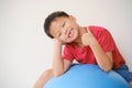 Cute Asian schoolboy child with missing teeth gesturing thumb up sign, Little kid losing his baby teeth