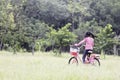 A cute Asian schoolgirl with long hair enjoying a bike ride