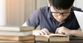 Cute asian teen boy doing your homework at home. Royalty Free Stock Photo