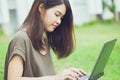 Cute Asian teen women student using laptop computer Royalty Free Stock Photo
