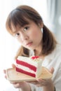 Cute Asian teenager holding strawberry cake Royalty Free Stock Photo