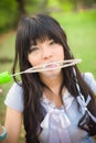 Cute Asian Thai girl is blowing a big soap bubble. Focus on the Royalty Free Stock Photo