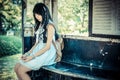Cute Asian Thai girl in vintage clothes is waiting alone