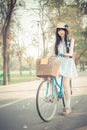 Cute Asian Thai girl in vintage clothing is standing with her bi Royalty Free Stock Photo