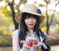 A cute Asian Thai girl in vintage is giving strawberry