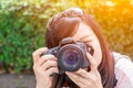 Cute asian woman black long hair shooting photo with digital camera. Royalty Free Stock Photo