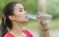 Cute asian woman drinking water on nature background Royalty Free Stock Photo