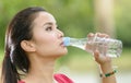 Cute asian woman drinking water on nature background Royalty Free Stock Photo