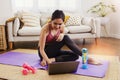 Cute Asian woman exercises living room study at home with exciting interest in researching the right way to lose weight.