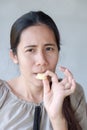 Cute asian woman tasting sour lemon. Royalty Free Stock Photo