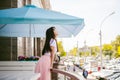 Cute asian young woman in summer cafe outdoors. girl In white T-shirt, with long hair in simple light cozy interior of restaurant Royalty Free Stock Photo