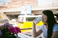 Cute asian young woman in summer cafe outdoors. girl In white T-shirt, with long hair in simple light cozy interior of restaurant Royalty Free Stock Photo