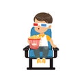 Cute astonished little boy in 3d glasses sitting on a blue chair, eating popcorn and watching 3D movie in the cinema