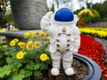 A cute astronaut standing in the garden.