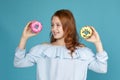 Cute attractive child girl holding yummy donut