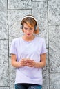 Cute attractive mature woman listening to music on mobile phone Royalty Free Stock Photo