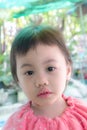 Cute baby Asian girl, little toddler child with adorable short bang hair looking at camera Royalty Free Stock Photo
